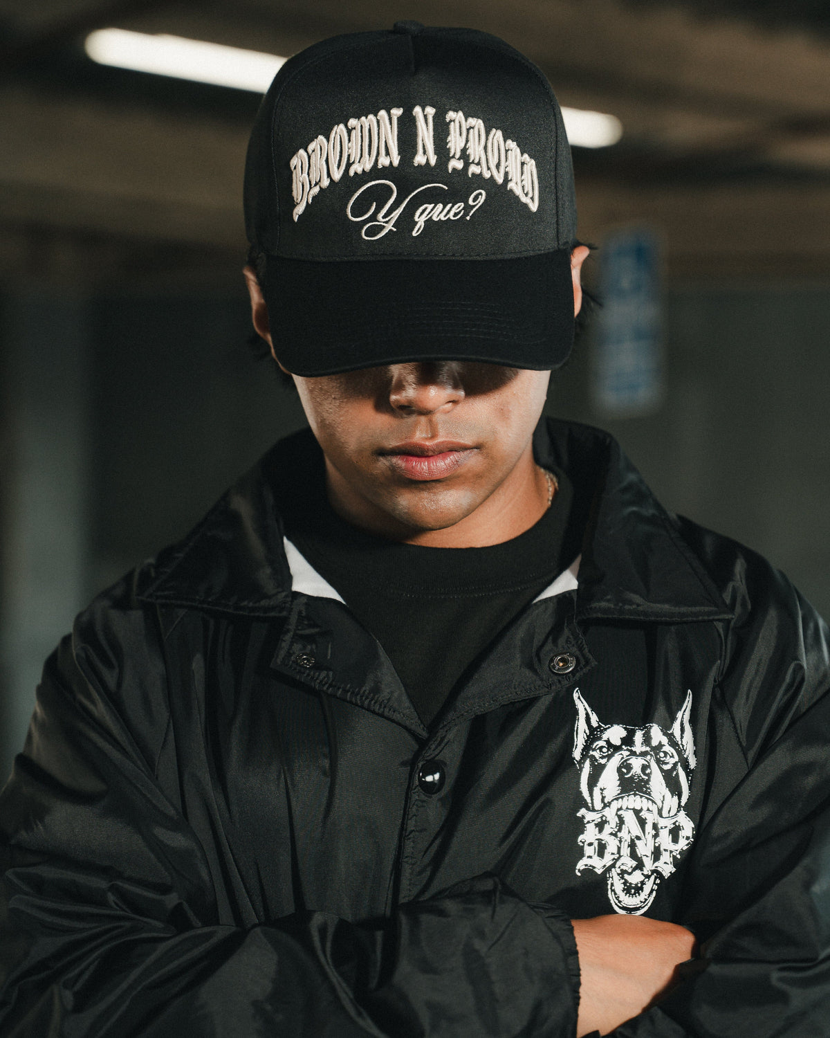 Brown N Proud Y Que? campaign: model in the Y Que? Snapback and Coach Jacket